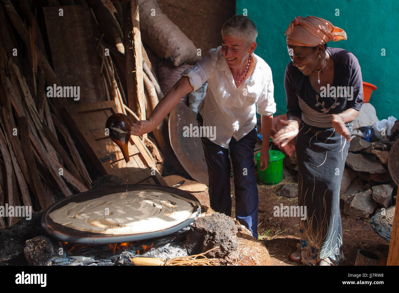 Modern Injera Making A volunteer learning how to make injera on an open fire in her compound ...