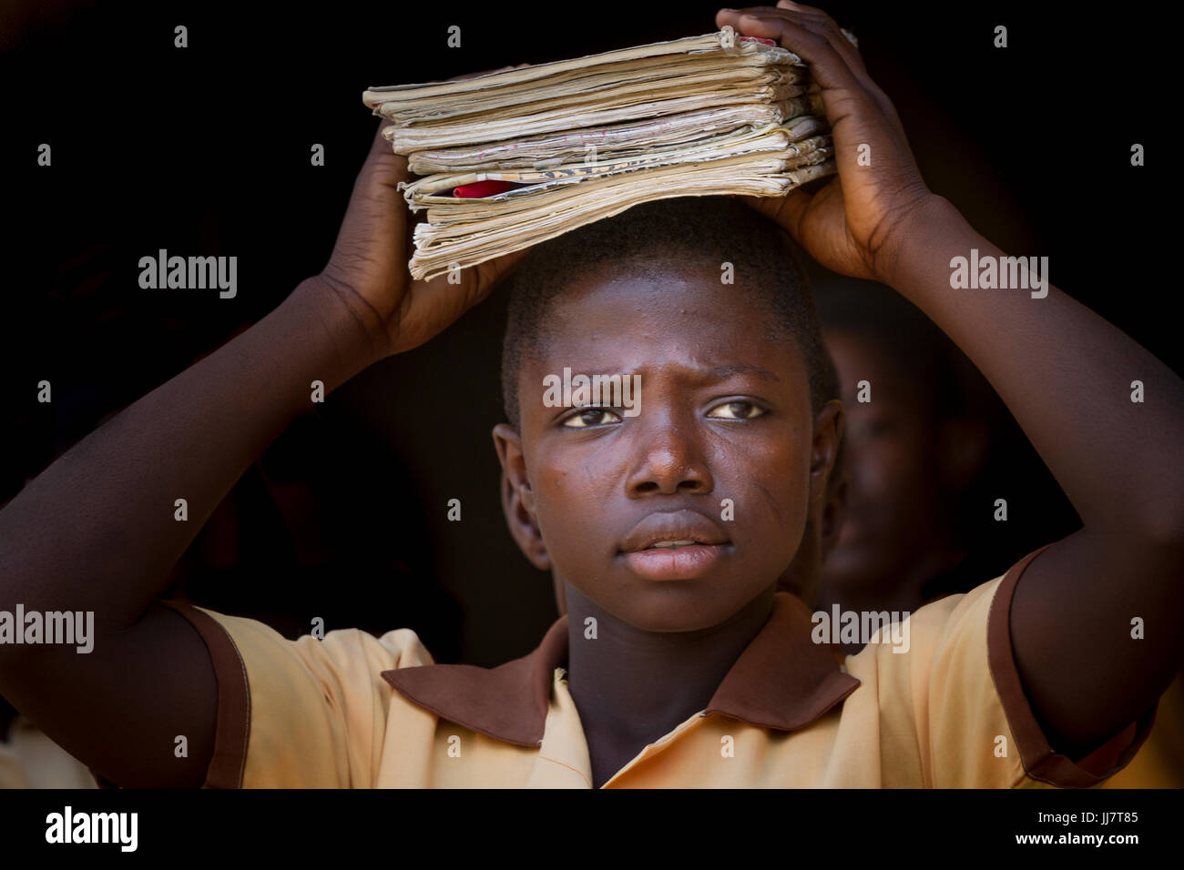 A school girl carrying her school books on her head, Ghana Stock Photo ...