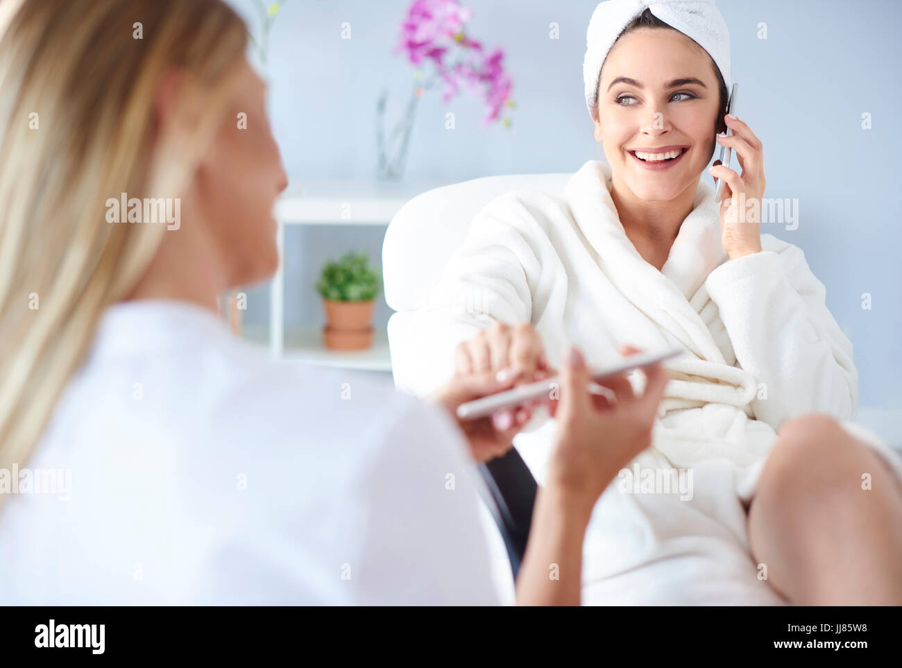 Young woman receiving manicure in nail salon Stock Photo