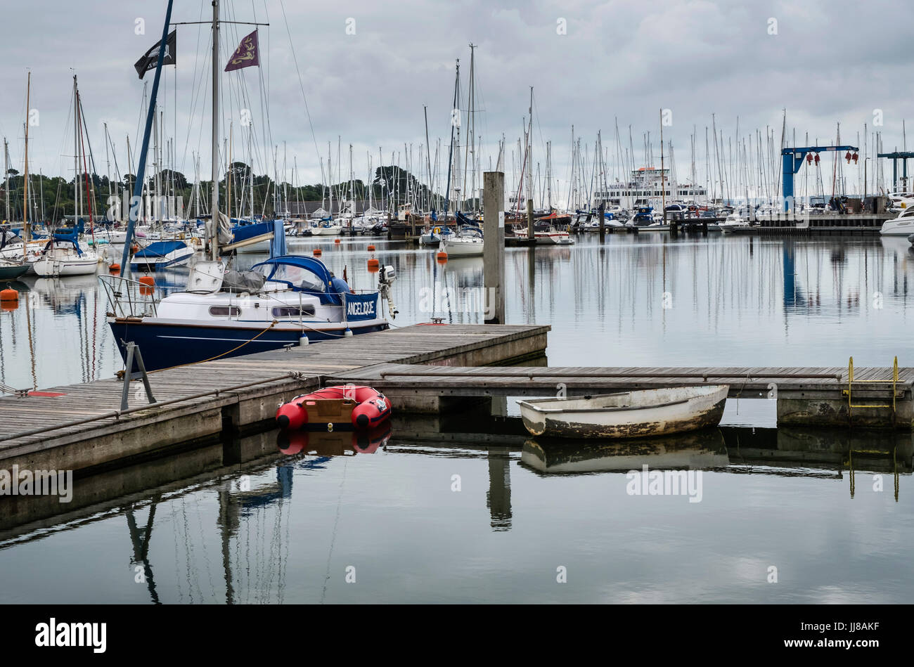Lymington Harbour, with view of boats, yachts and mooring pontoons, from Town Quay towards the Lymington River, Hampshire, England, UK Stock Photo