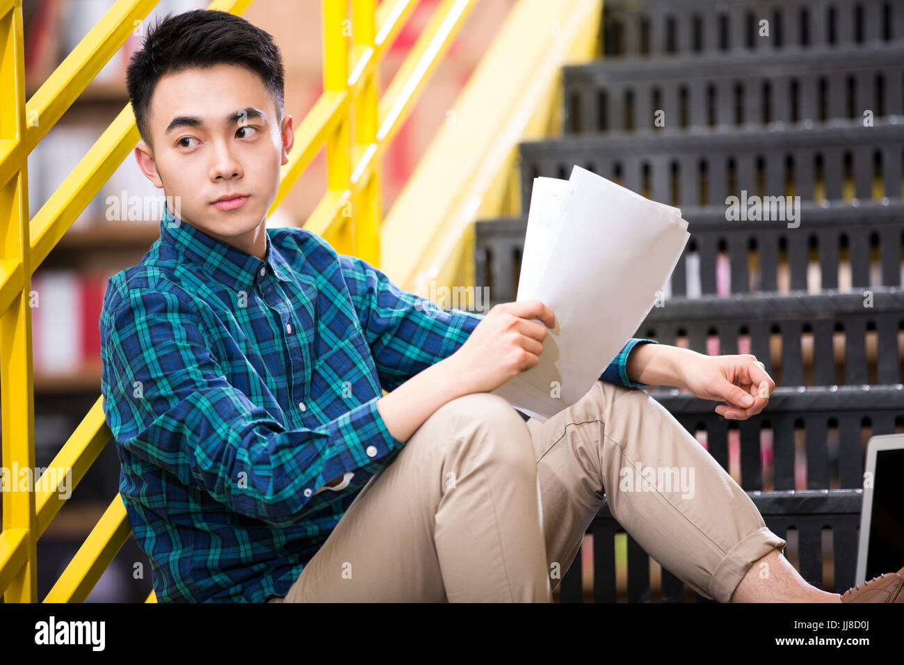 Young man  work on the stairs Stock Photo