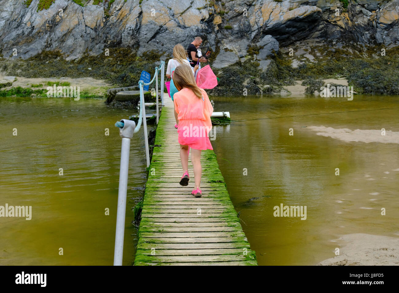 Wooden bridge on the route between Crantock and Newquay at low tide. Stock Photo