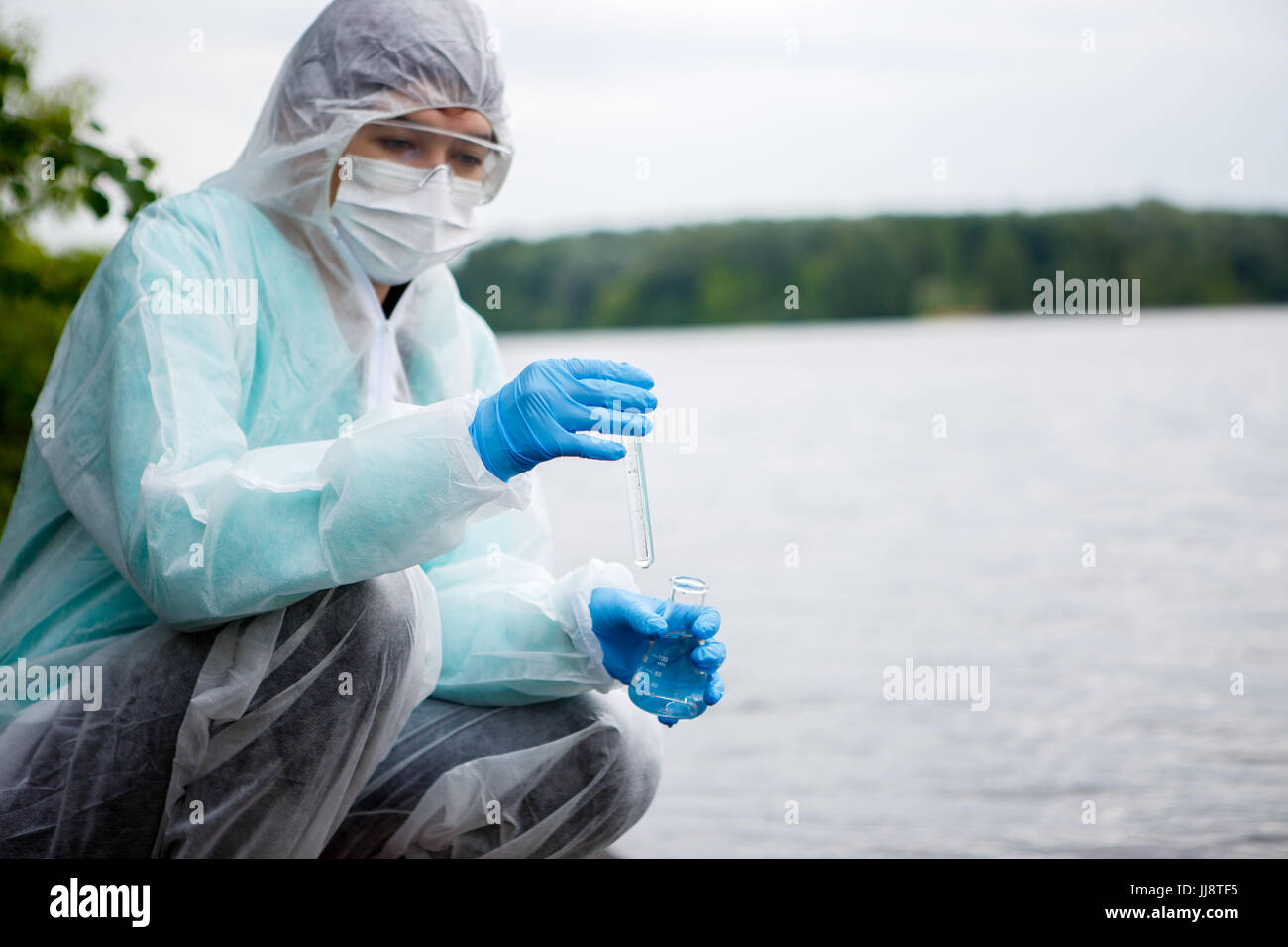 Photo of chemist takes water for examination in pond Stock Photo Alamy