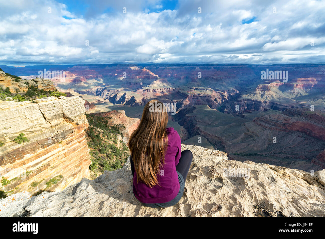 Beautiful woman looking out at the Grand Canyon from the South Rim ...
