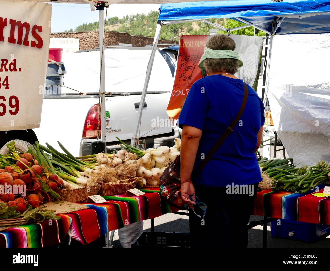 Woman looking at produce, outdoor farmers market, Flagstaff, Arizona