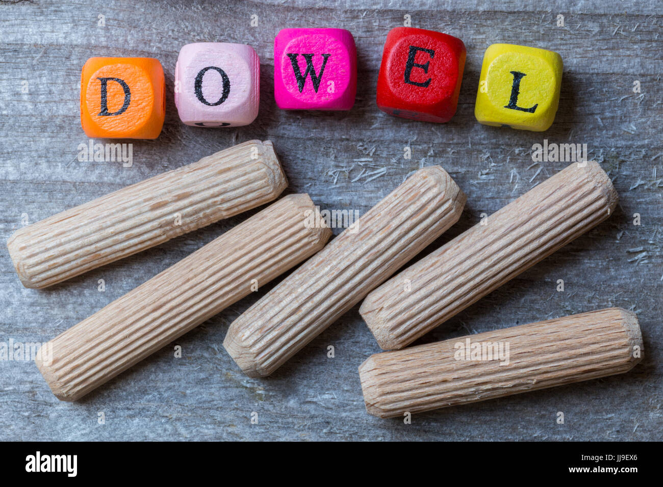 Letter cubes and dowels on gray wood visualization Stock Photo