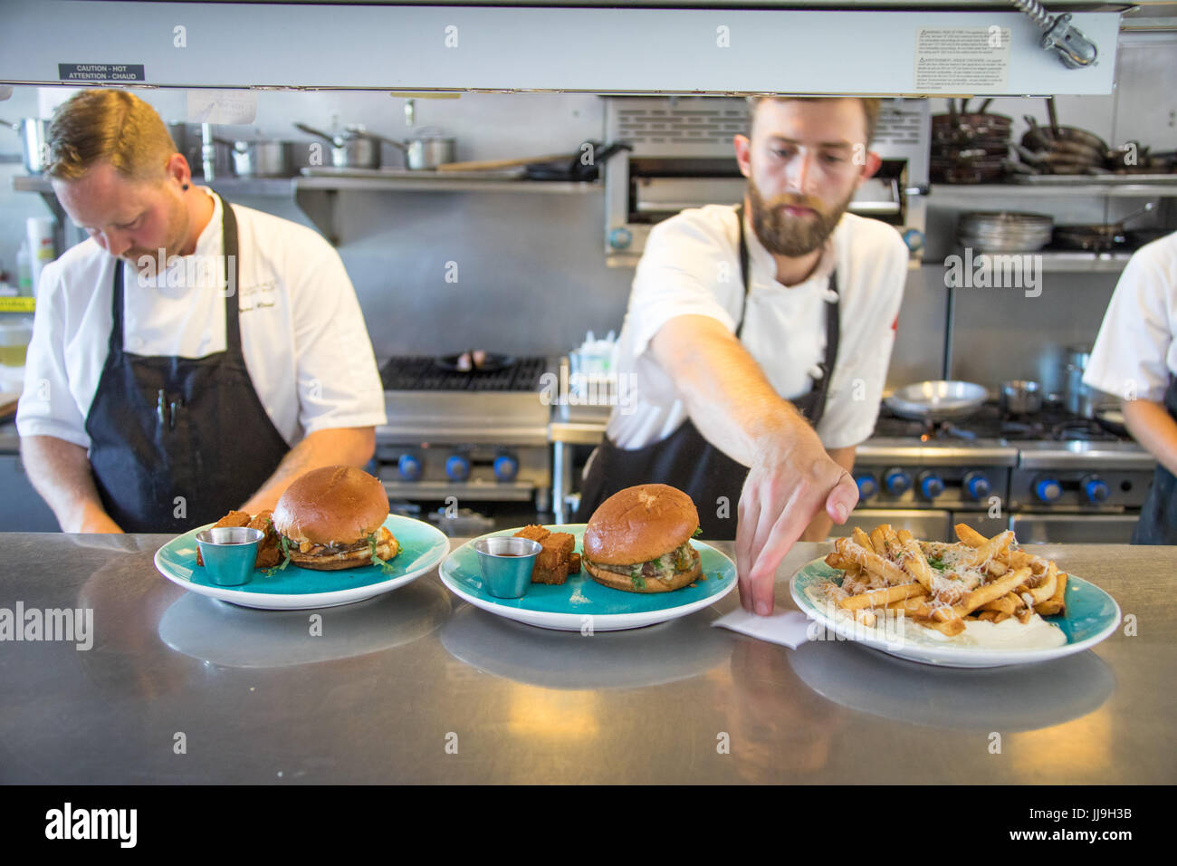 Chefs at work in Nomad Restaurant, Vancouver, Canada Stock Photo