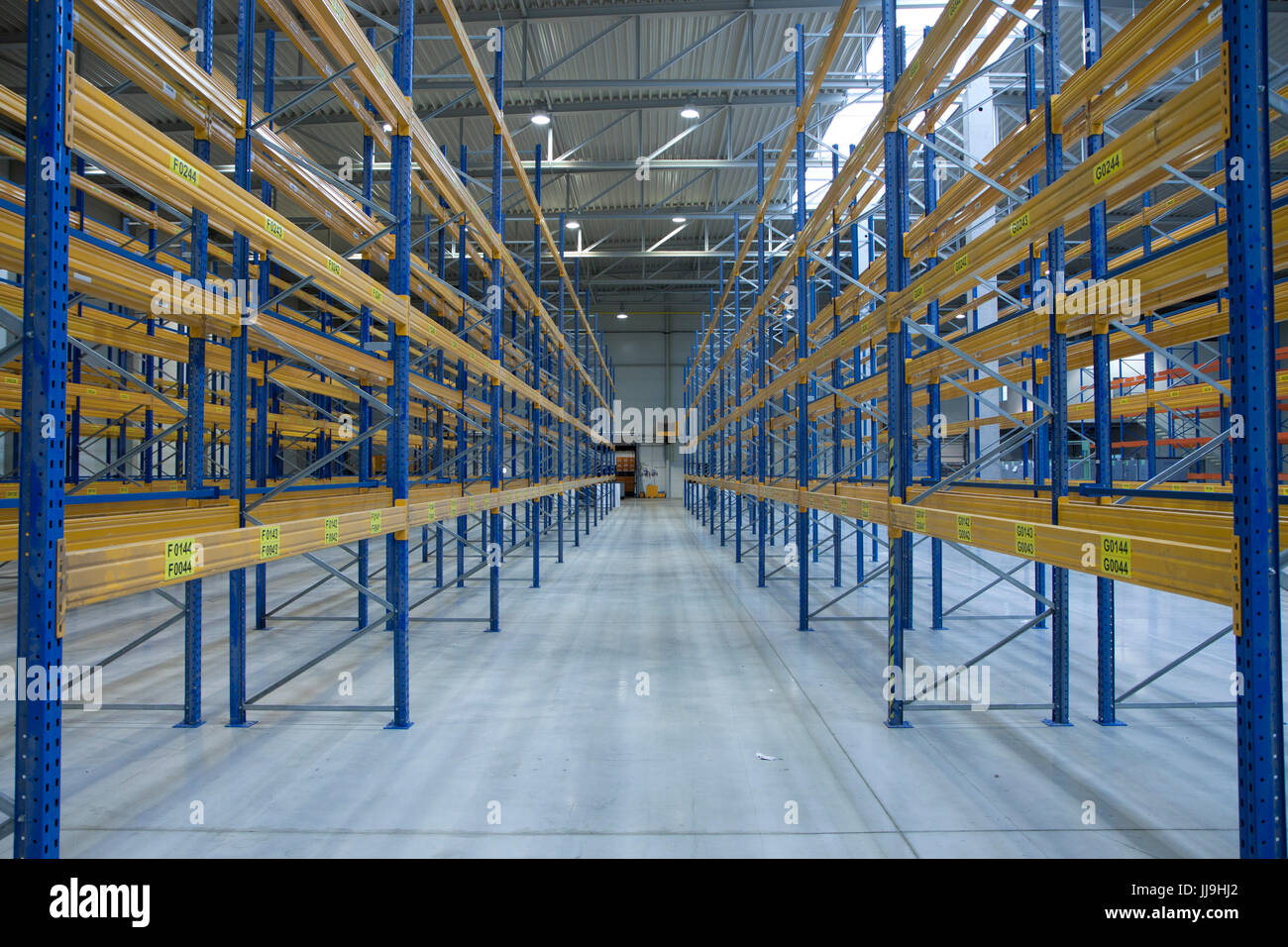 empty new warehouse prepared to start business - with racks Stock Photo