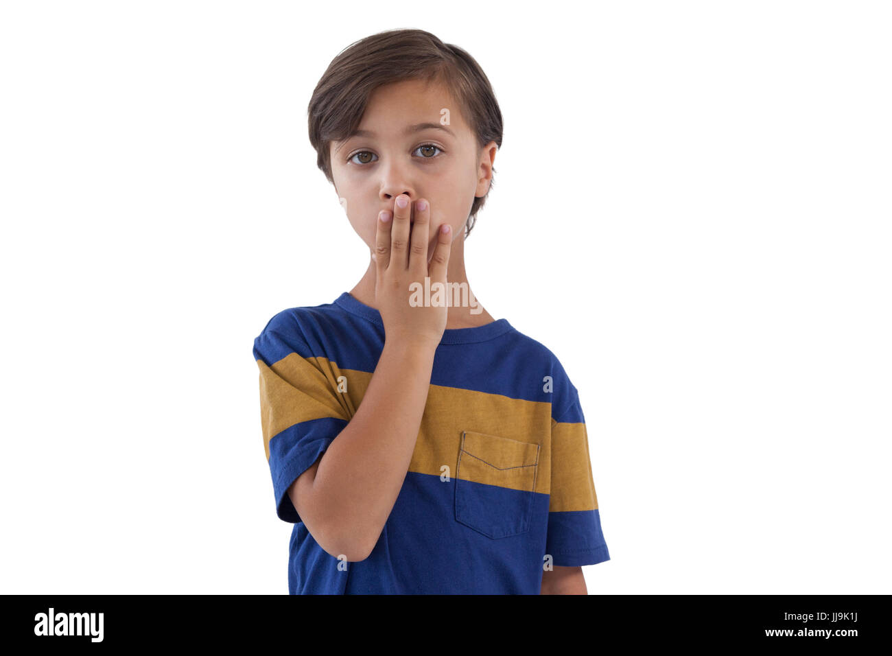 Portrait of shocked boy standing against white background Stock Photo