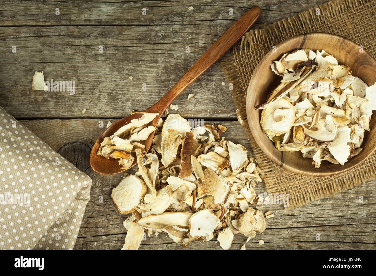 Dried mushrooms in wooden table. Pile of dried edible mushrooms for