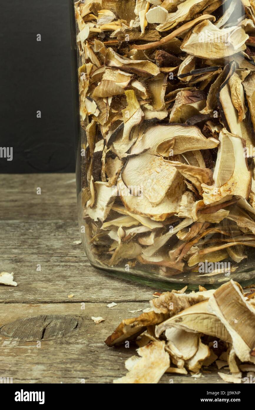 Dried mushrooms in wooden table. Pile of dried edible mushrooms for