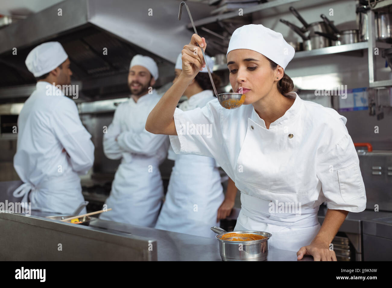 https://c8.alamy.com/comp/JJ9KNW/chef-tasting-food-from-spoon-in-kitchen-at-restaurant-JJ9KNW.jpg
