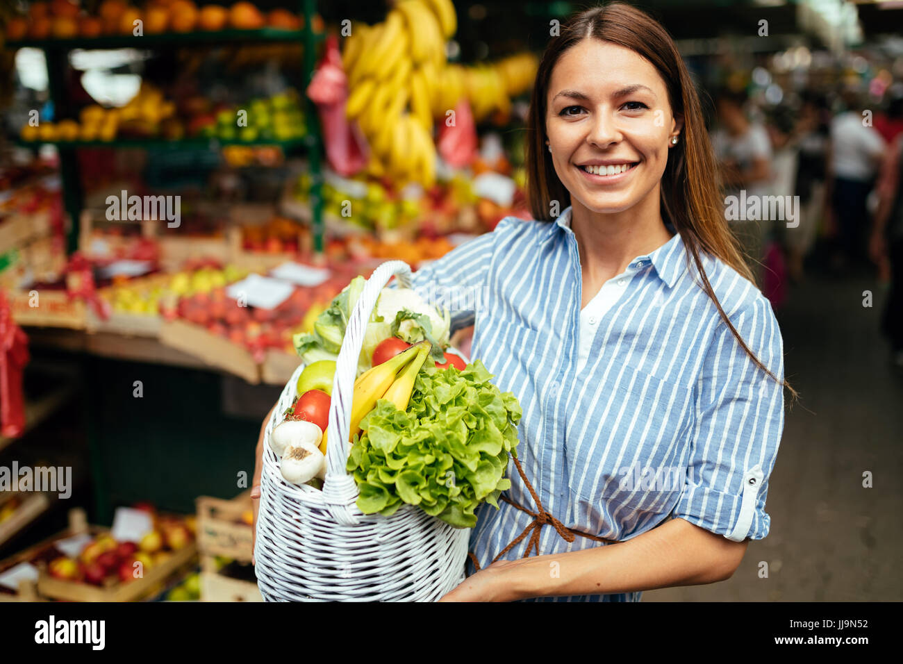 Portrait of beautiful woman holding shopping basket Stock Photo - Alamy