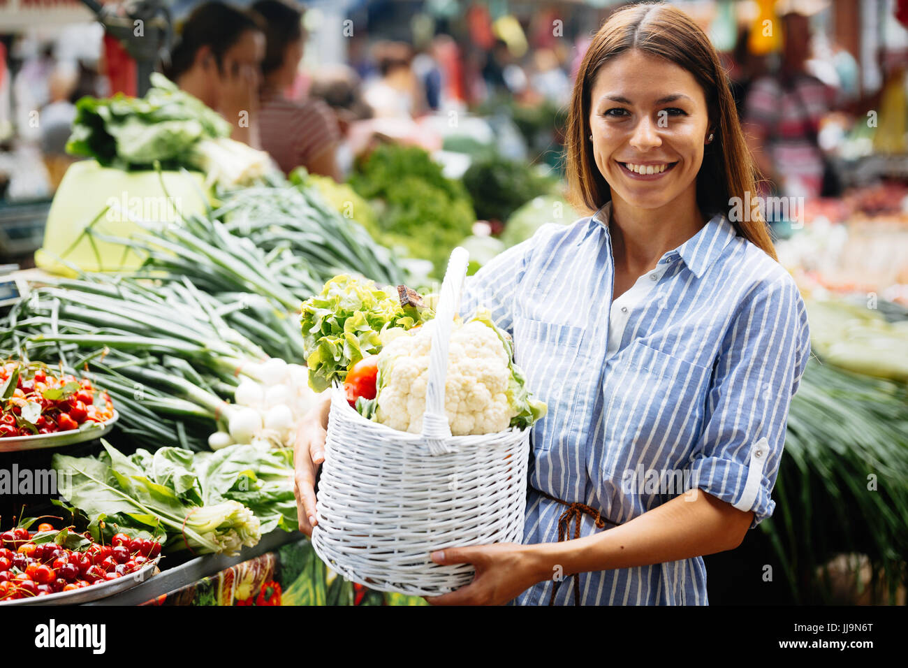 Portrait of beautiful woman holding shopping basket Stock Photo - Alamy
