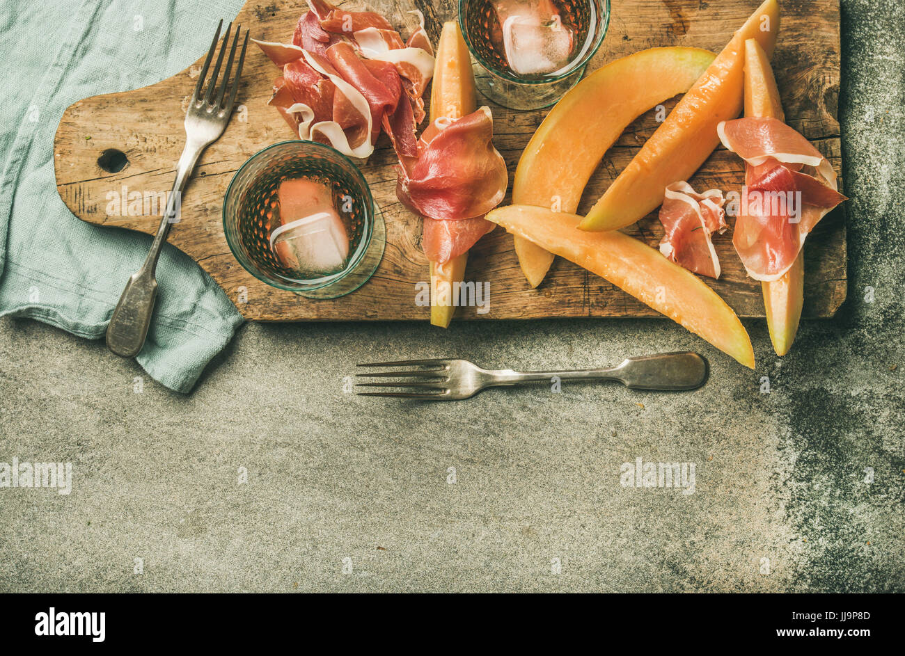 Summer wine party set with rose wine, prosciutto and melon Stock Photo Alamy