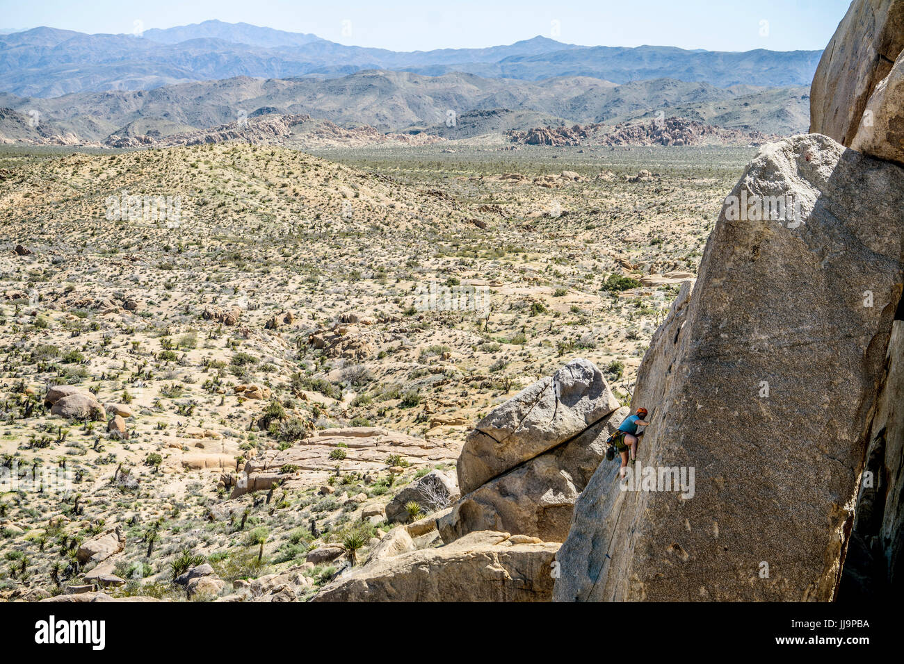 A man lead climbing a route in Joshua Tree National Park. Stock Photo