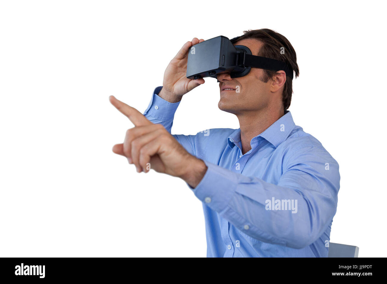 Businessman gesturing while using  virtual reality simulator against white background Stock Photo