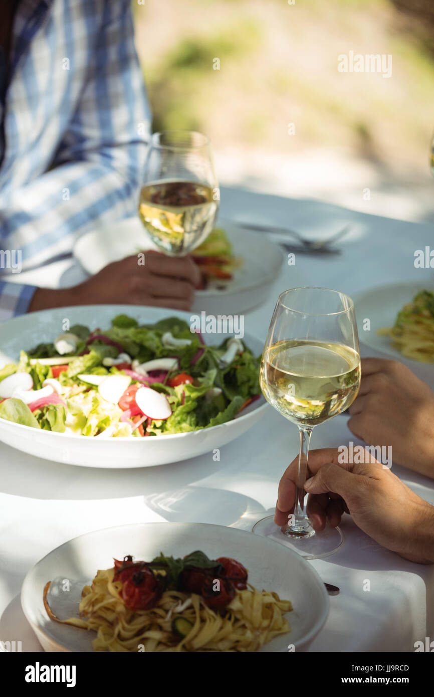 Close-up of food and wine glass on dining table in restaurant Stock Photo