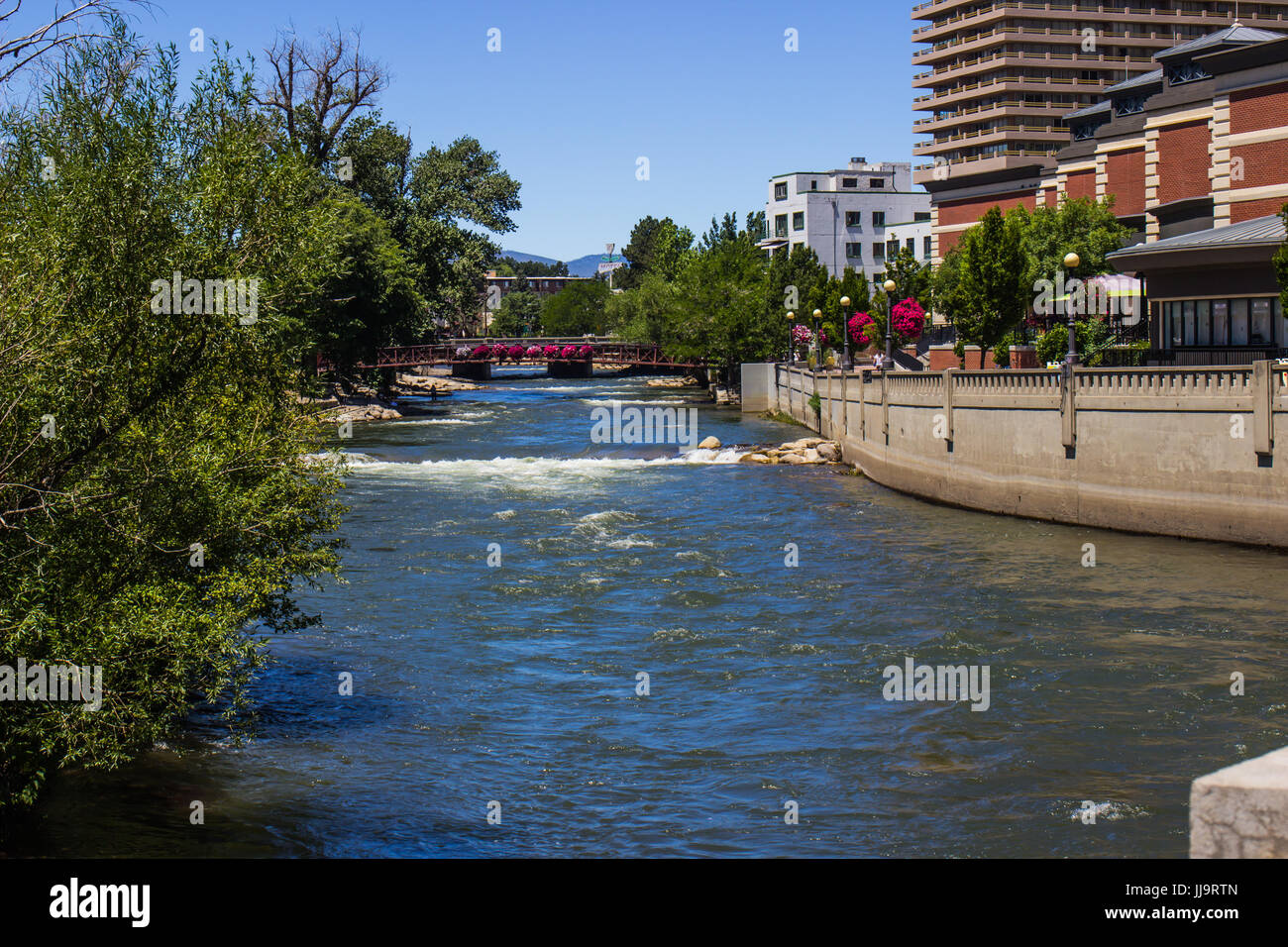 Walking Bridge In Distance Along River Walk On Truckee River In Reno, Nevada Stock Photo