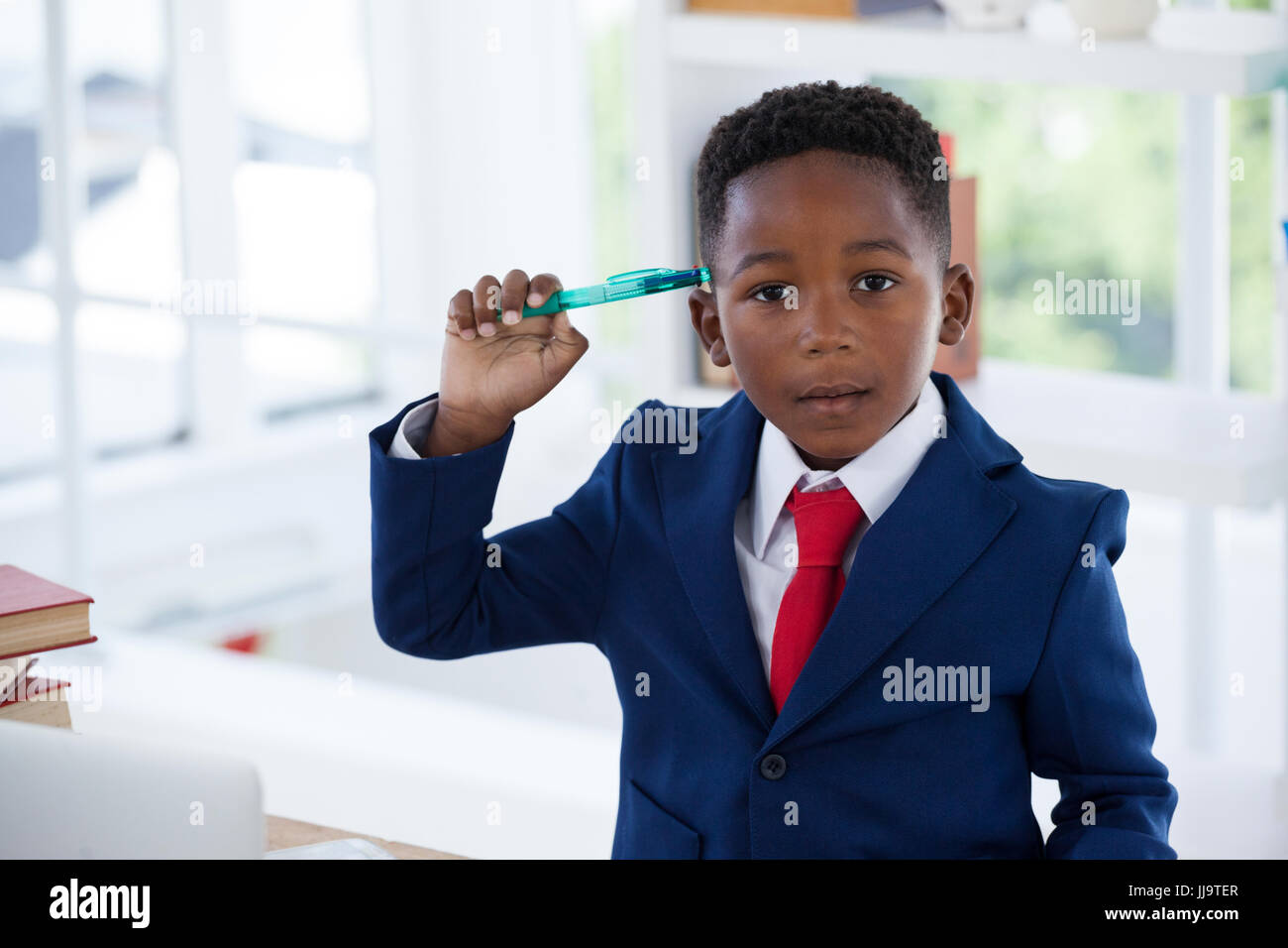 Close up portrait of businessman holding pen in office Stock Photo - Alamy