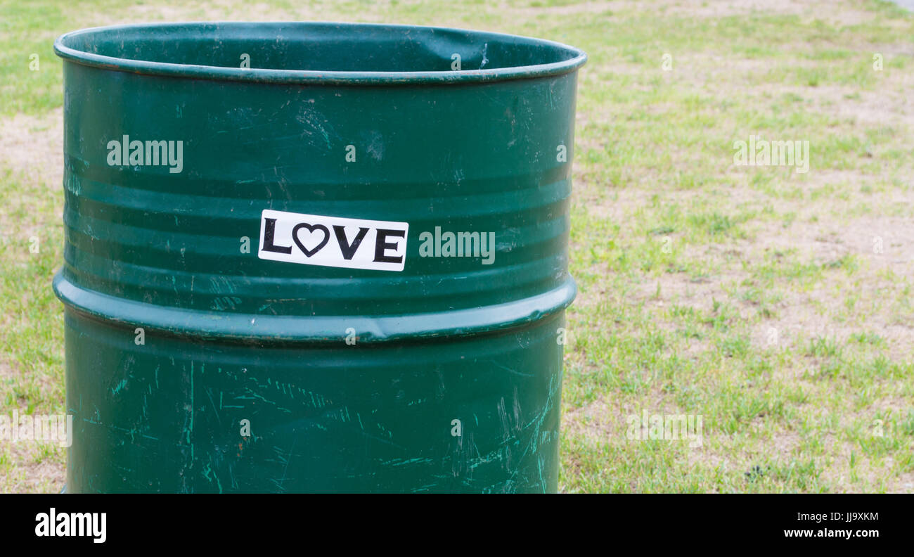 https://c8.alamy.com/comp/JJ9XKM/black-and-white-love-bumper-sticker-on-green-trash-barrel-in-park-JJ9XKM.jpg