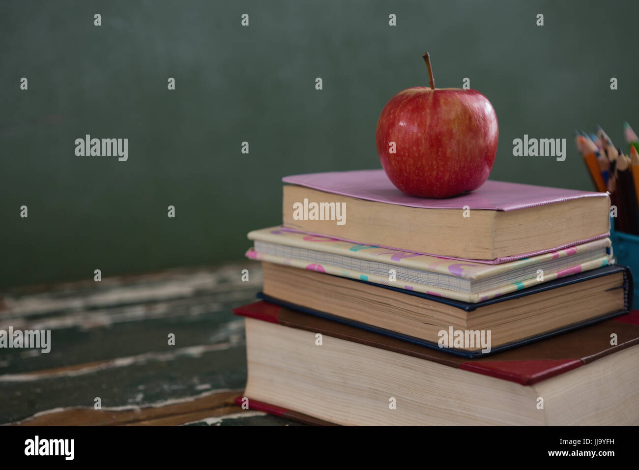 Book Stack With Ruler Apple Close-up of apple on book stack Stock Photo - Alamy