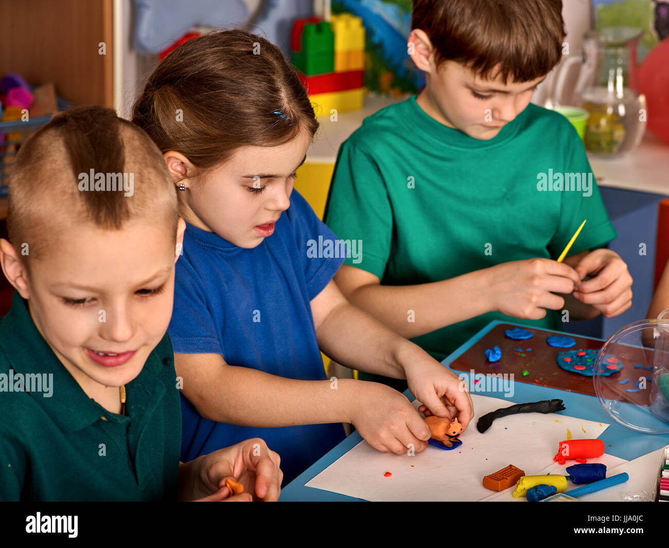 Plasticine modeling clay in children class. Teacher teaches in school ...