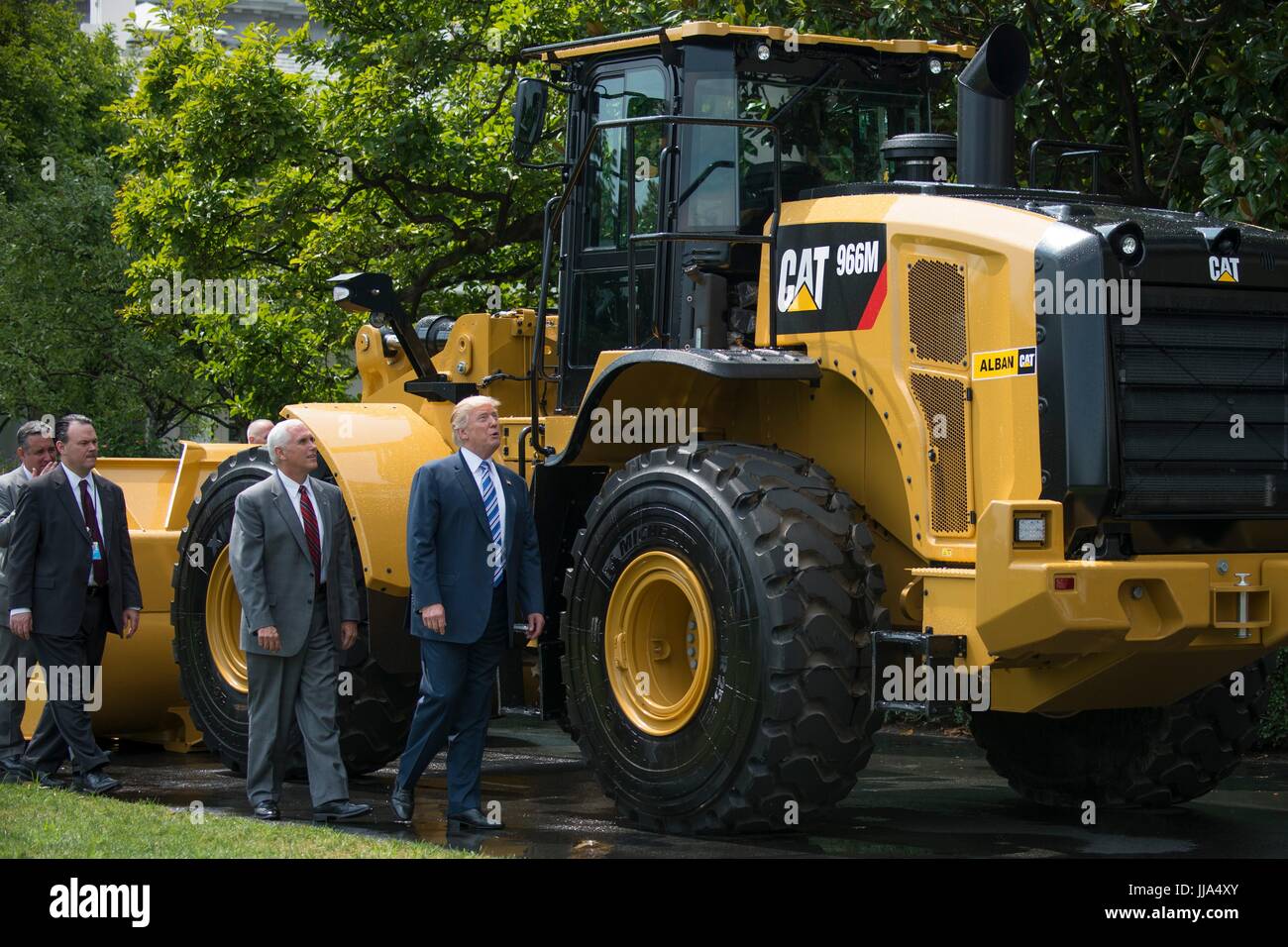 Washington, United States Of America. 17th July, 2017. U.S President Donald Trump and Vice President Mike Pence look up at a Caterpillar Large Wheel Loader construction front end loader during the Made in America Product Showcase on the South Lawn of the White House July 17, 2017 in Washington, DC. Credit: Planetpix/Alamy Live News Stock Photo