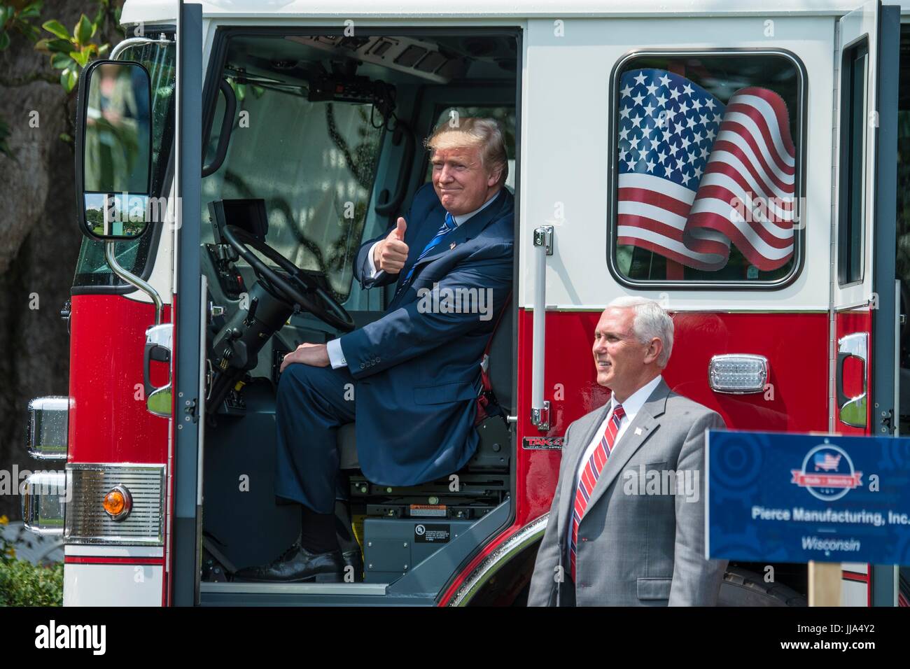 Washington, United States Of America. 17th July, 2017. U.S President Donald Trump gives a thumbs up while sitting behind the wheel of a Pierce fire truck as Vice President Mike Pence looks on during the Made in America Product Showcase on the South Lawn of the White House July 17, 2017 in Washington, DC. Credit: Planetpix/Alamy Live News Stock Photo