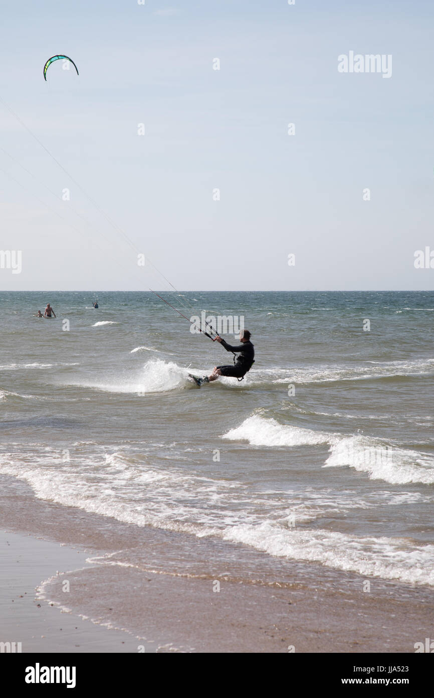 Brancaster, Norfolk, UK. 18th July 2017. UK Weather: Hot sunny spells on Norfolk coast. Kite surfers and birdlife on beach and marches Credit: WansfordPhoto/Alamy Live News Stock Photo