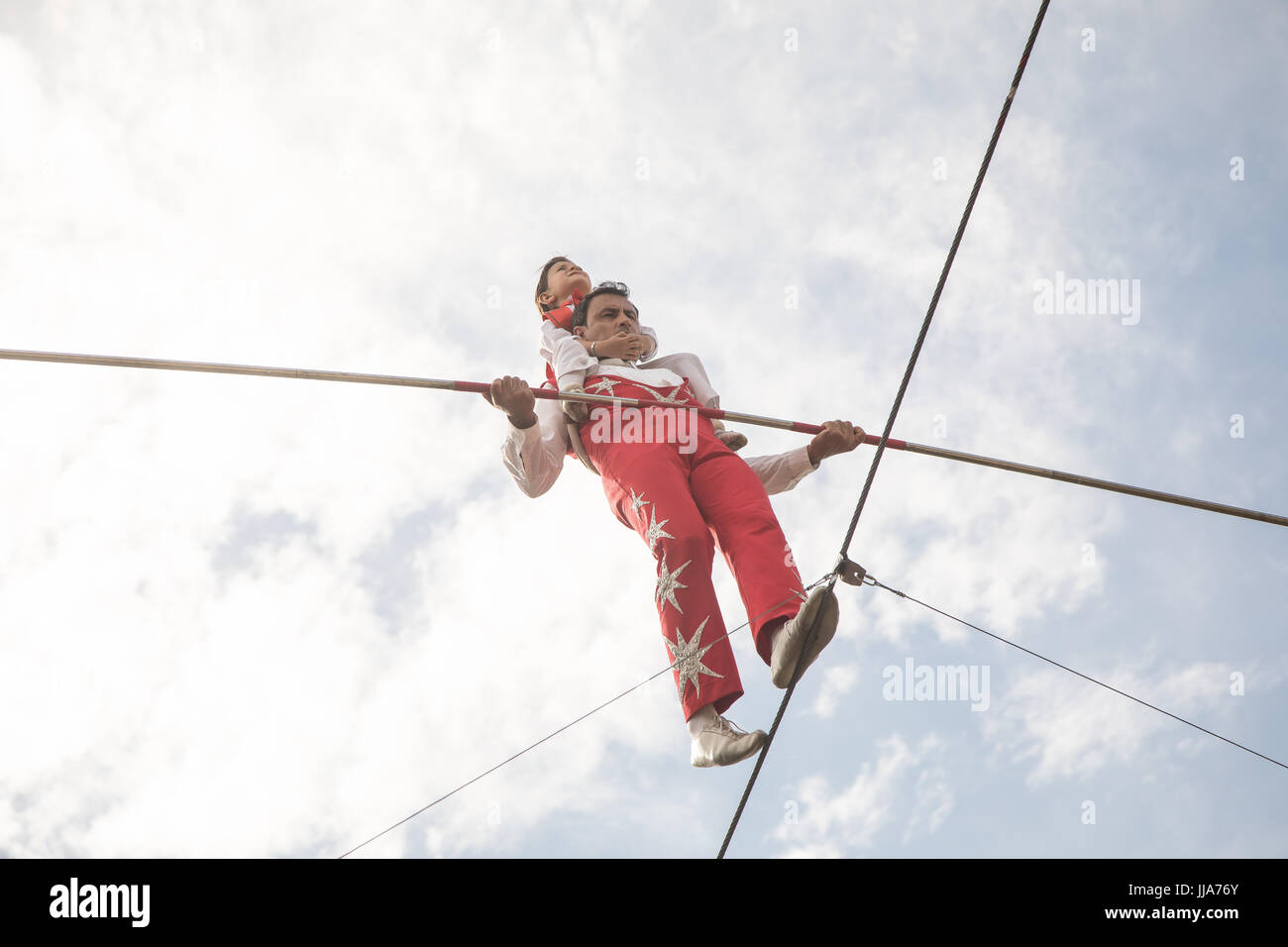 Tomas rides on the back of his father Robinson Cortes on the highwire