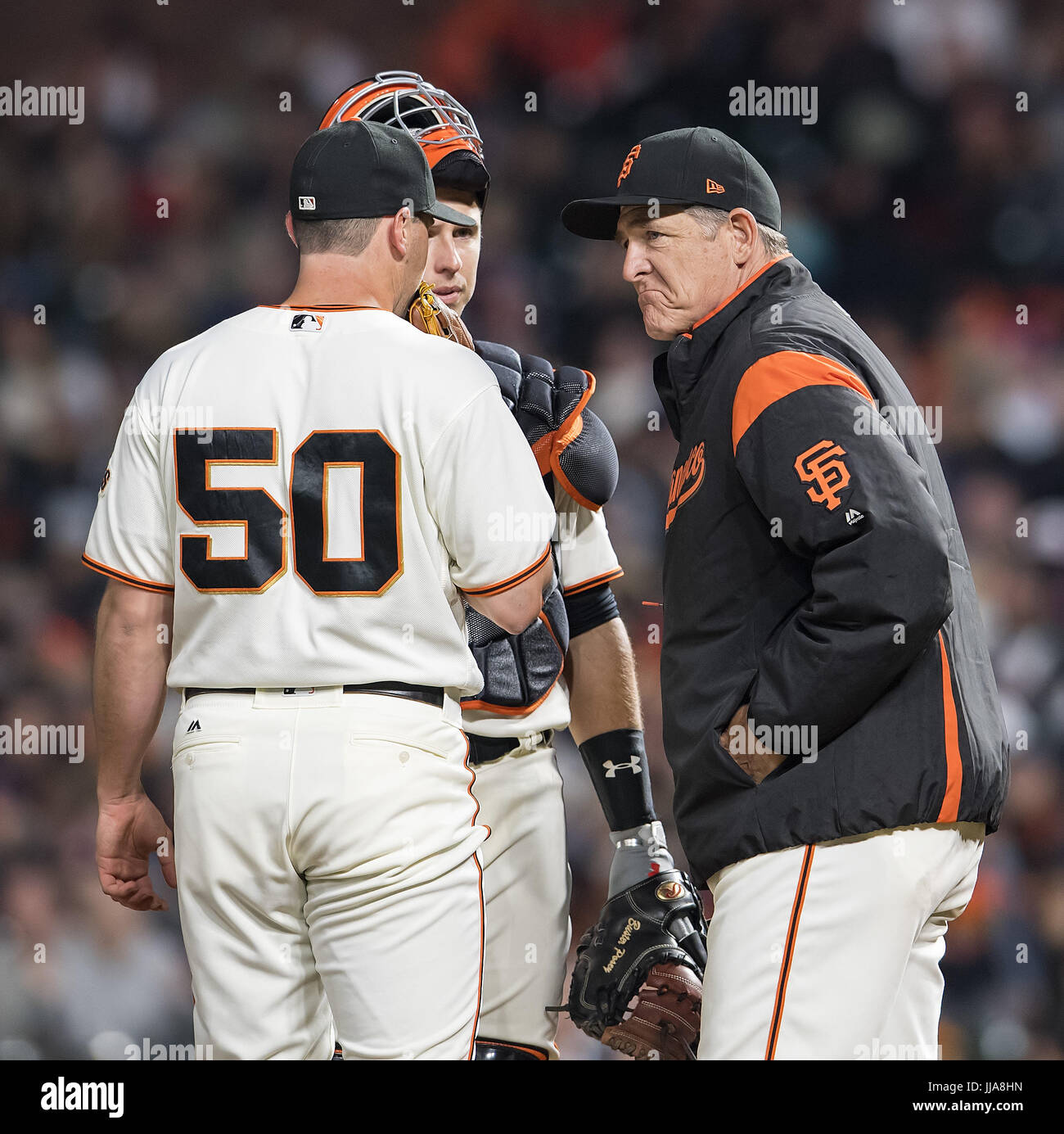 San Francisco, California, USA. 18th July, 2017. In the seventh inning with two outs, San Francisco Giants pitching coach Dave Righetti (19) checks in with starting pitcher Ty Blach (50), and catcher Buster Posey (28) at the mound, during a MLB baseball game between the Cleveland Indians and the San Francisco Giants at AT&T Park in San Francisco, California. Valerie Shoaps/CSM/Alamy Live News Stock Photo