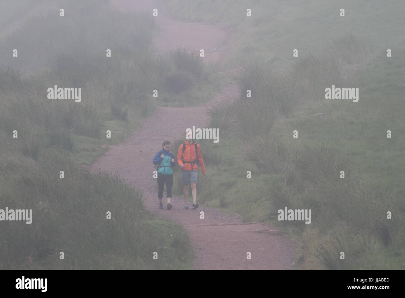 Pont Yr Daf, Brecon Beacons, South Wales, UK. 19th July, 2017. UK Weather: People walk the decent from Pen Y Fan in severe fog today, as humid temperatures reach in the low 30's in parts of the country. Credit: Andrew Bartlett/Alamy Live News Stock Photo