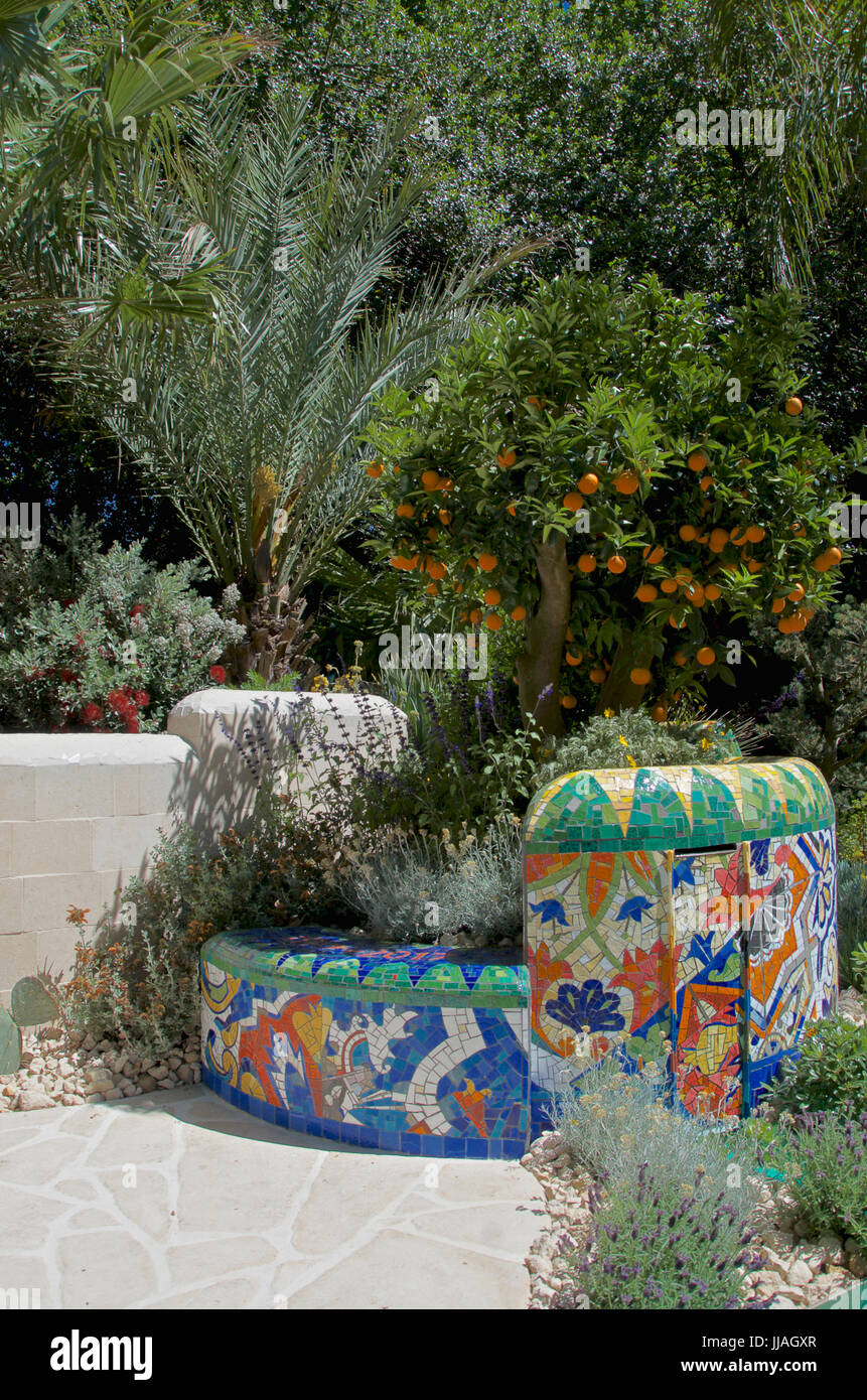 Mediterranean planting of Citrus and palm trees in The Viking Cruises Garden of Inspiration at RHS Chelsea Flower Show 2017 Stock Photo