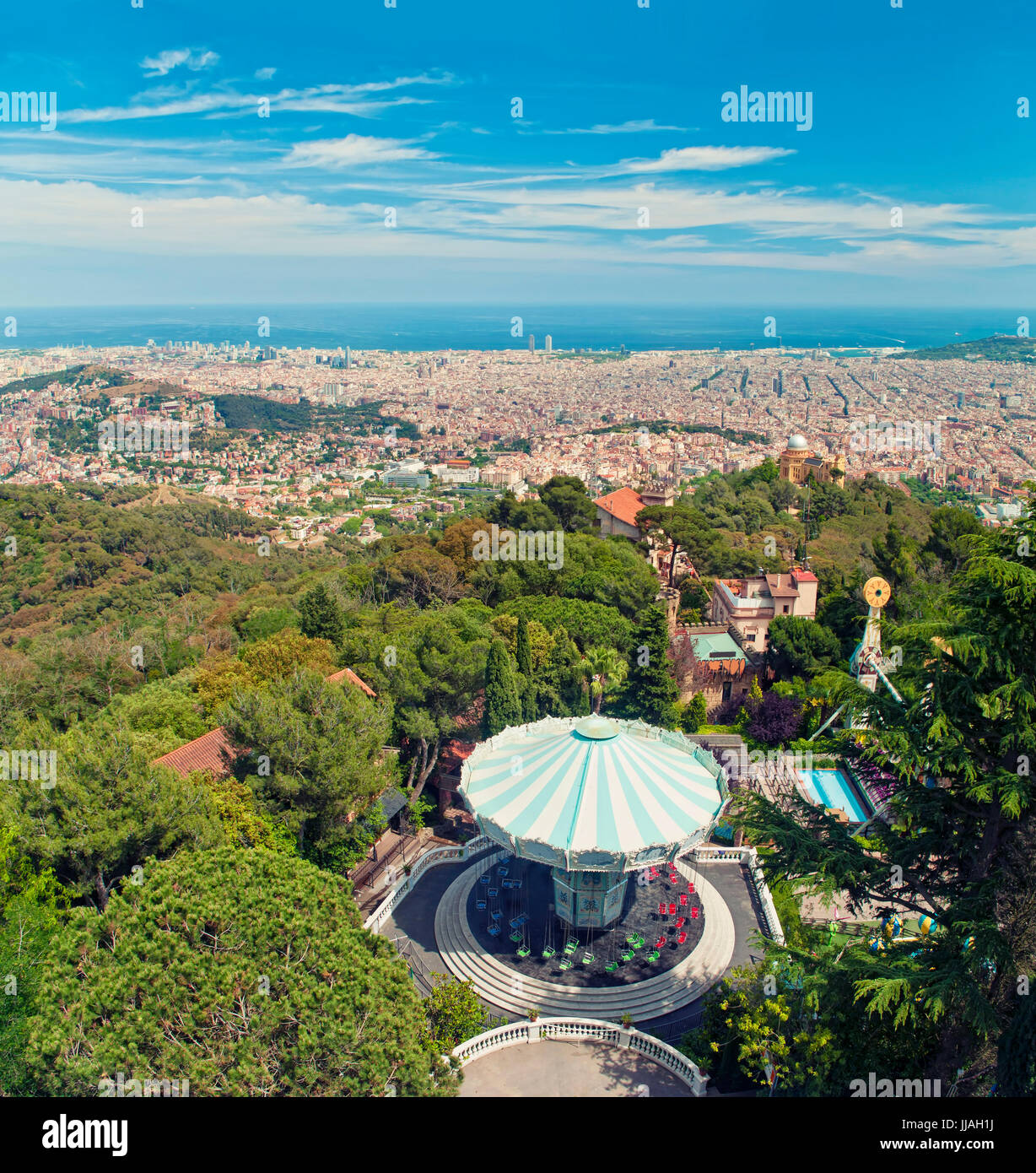 cross-processed image of Barcelona city view and amusement park from top of Tibidabo mountain on sunny summer day, Barcelona, Catalonia, Spain Stock Photo