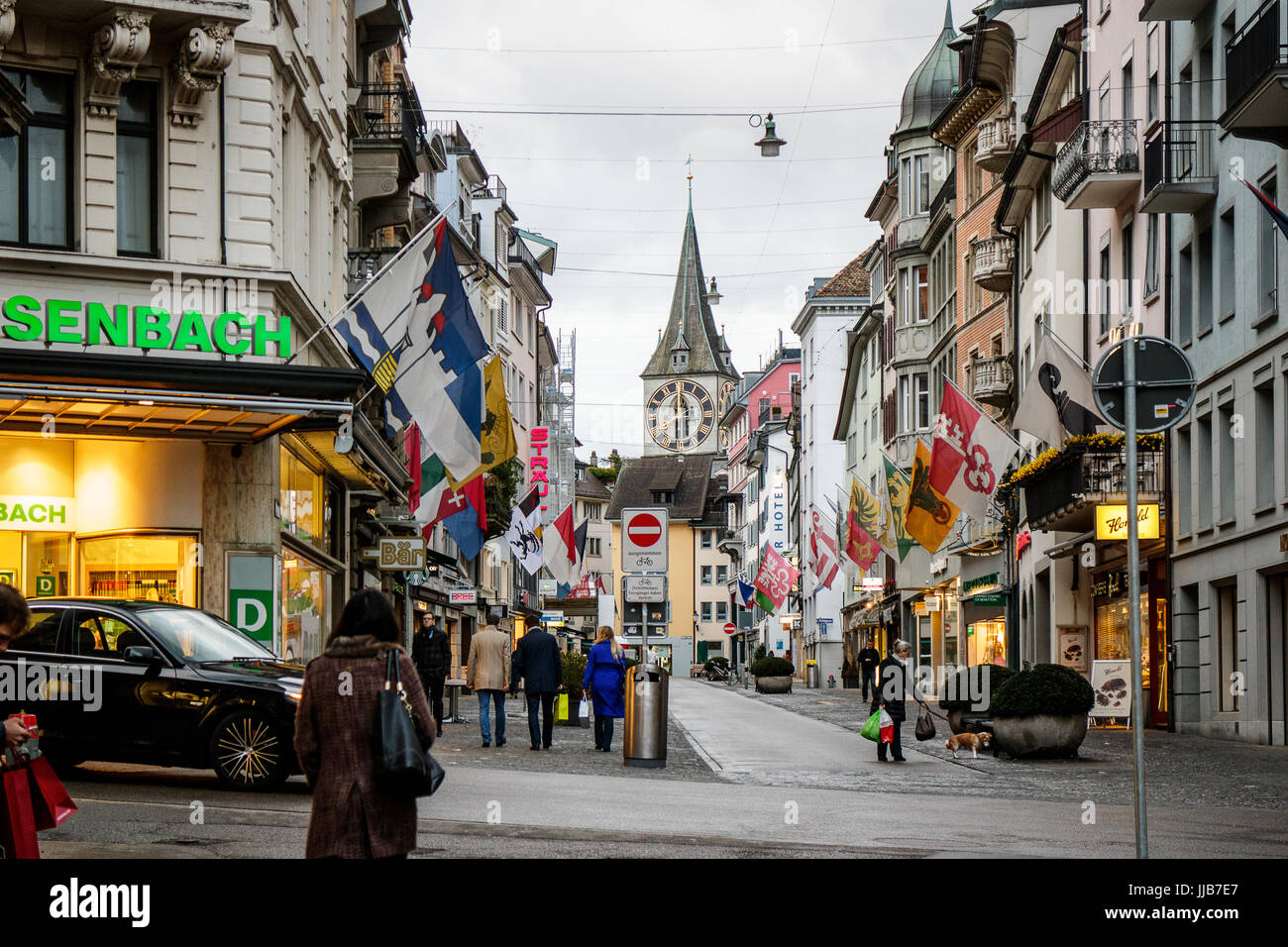 St. Peter Church clock tower, the largest clock face in Europe,  watches over the busy and historic Rennweg Street, Zurich, Switzerland. Stock Photo