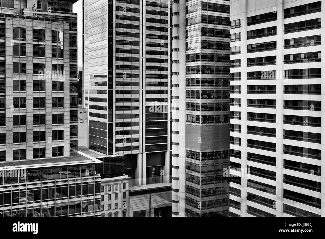 Densly constructed high-rise buildings in Sydney city CBD in black-white. High concentration of business offices and headquarters reflecting busy mode Stock Photo