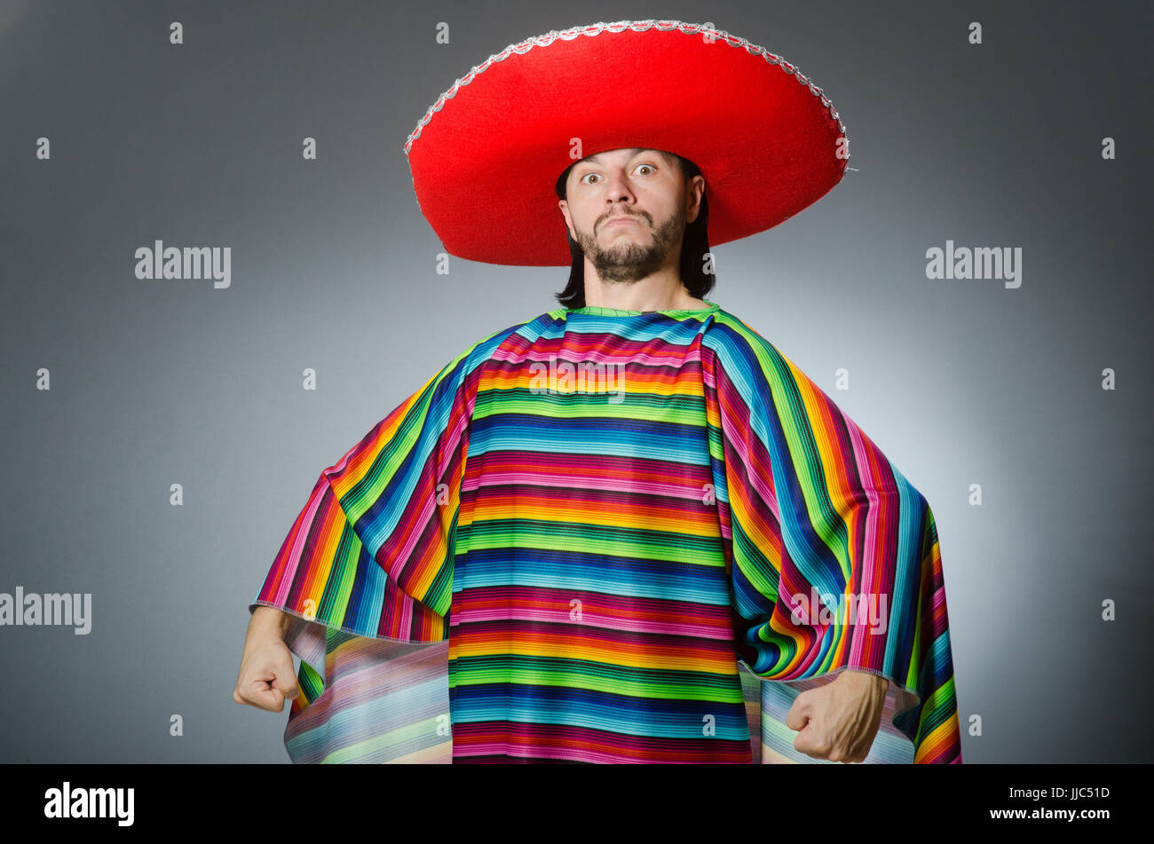 Man in a vivid mexican poncho gray background isolated Stock Photo - Alamy