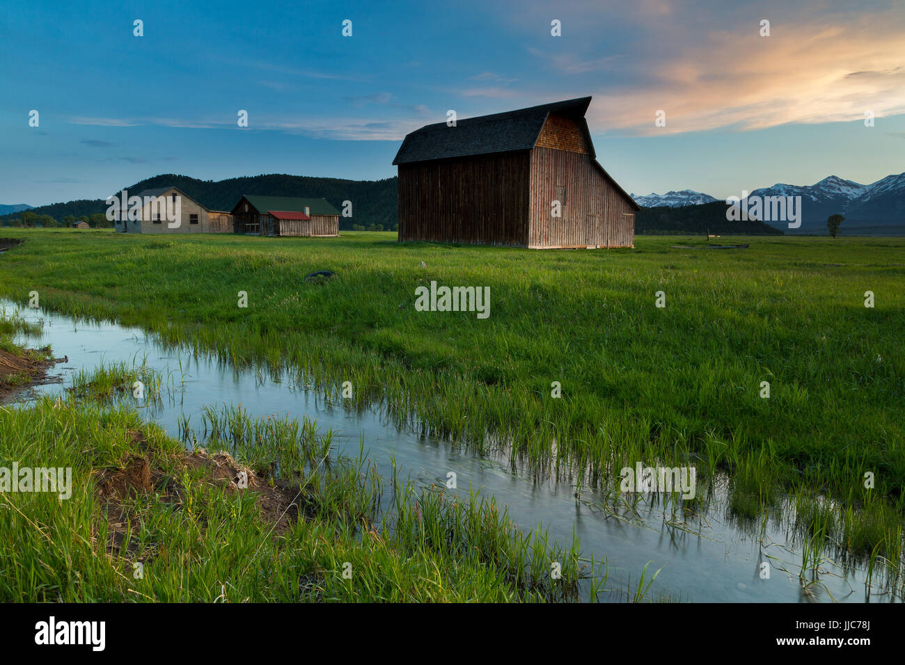 A series of houses and barns on the north end of Mormon Row and Jackson Hole in front of the Teton Mountains. Grand Teton National Park, Wyoming Stock Photo