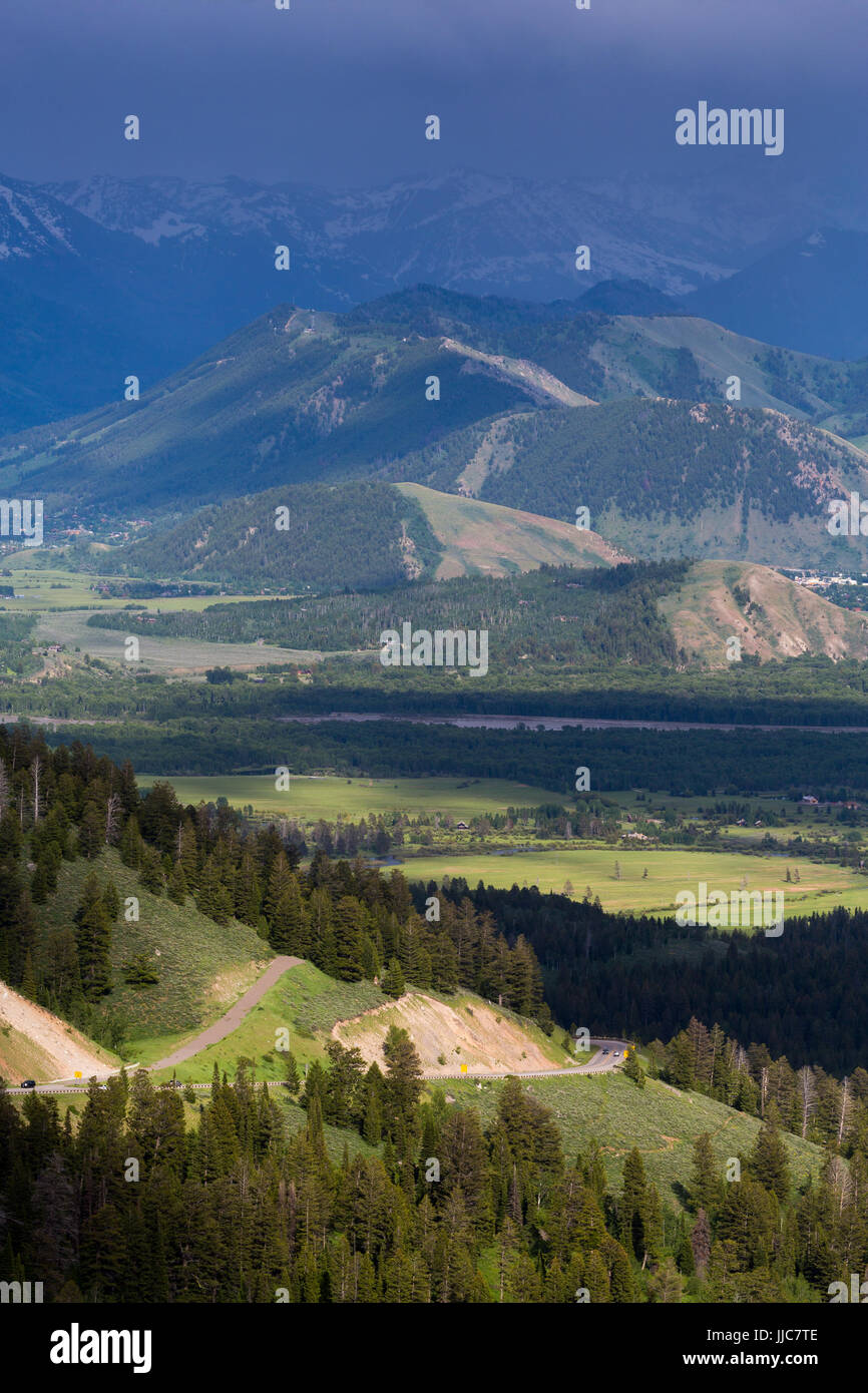 Highway 22 descending the Teton Mountains below stormy weather gathering above Jackson Hole