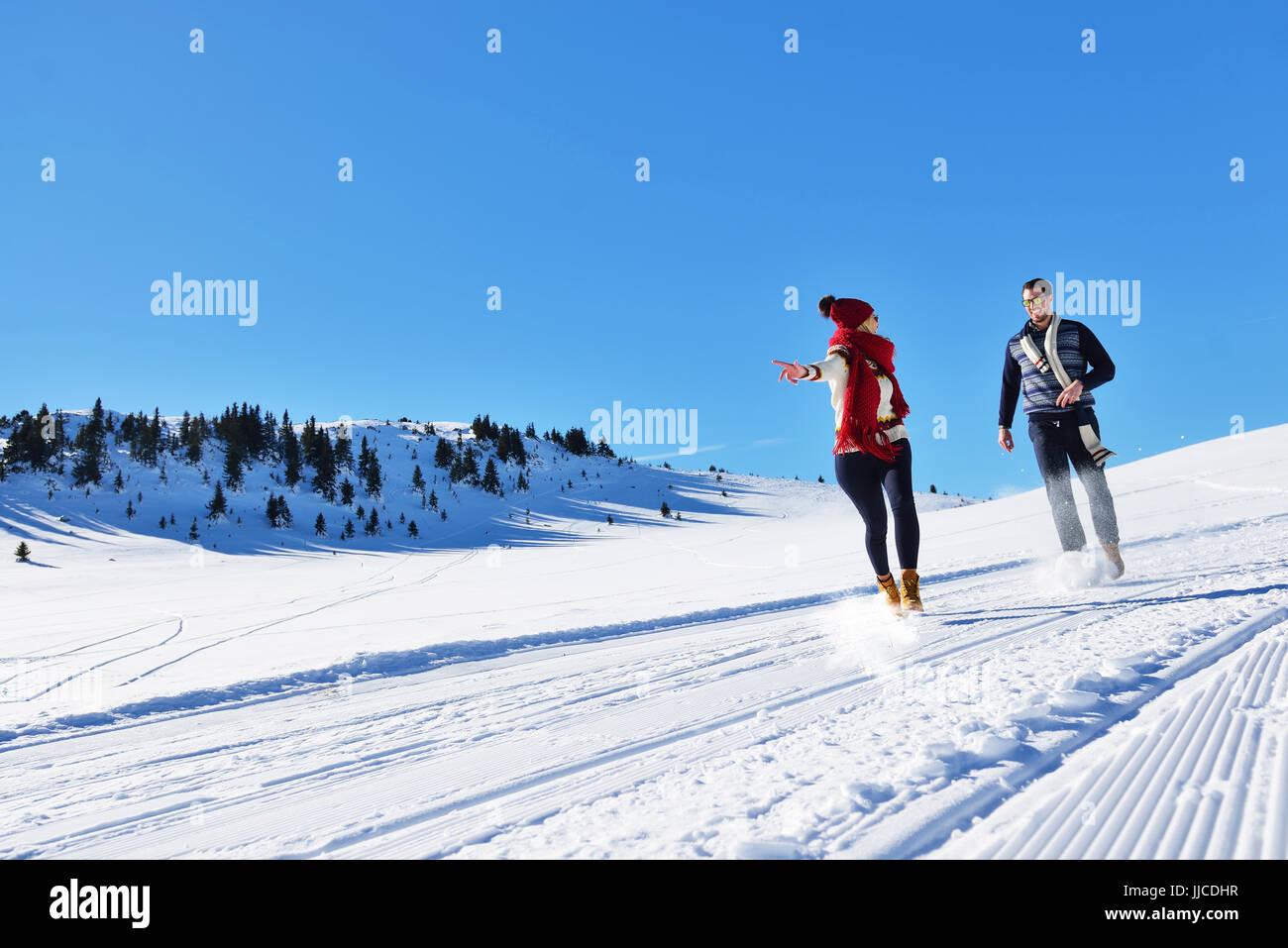 Cheerful young couple having fun in winter park Stock Photo - Alamy
