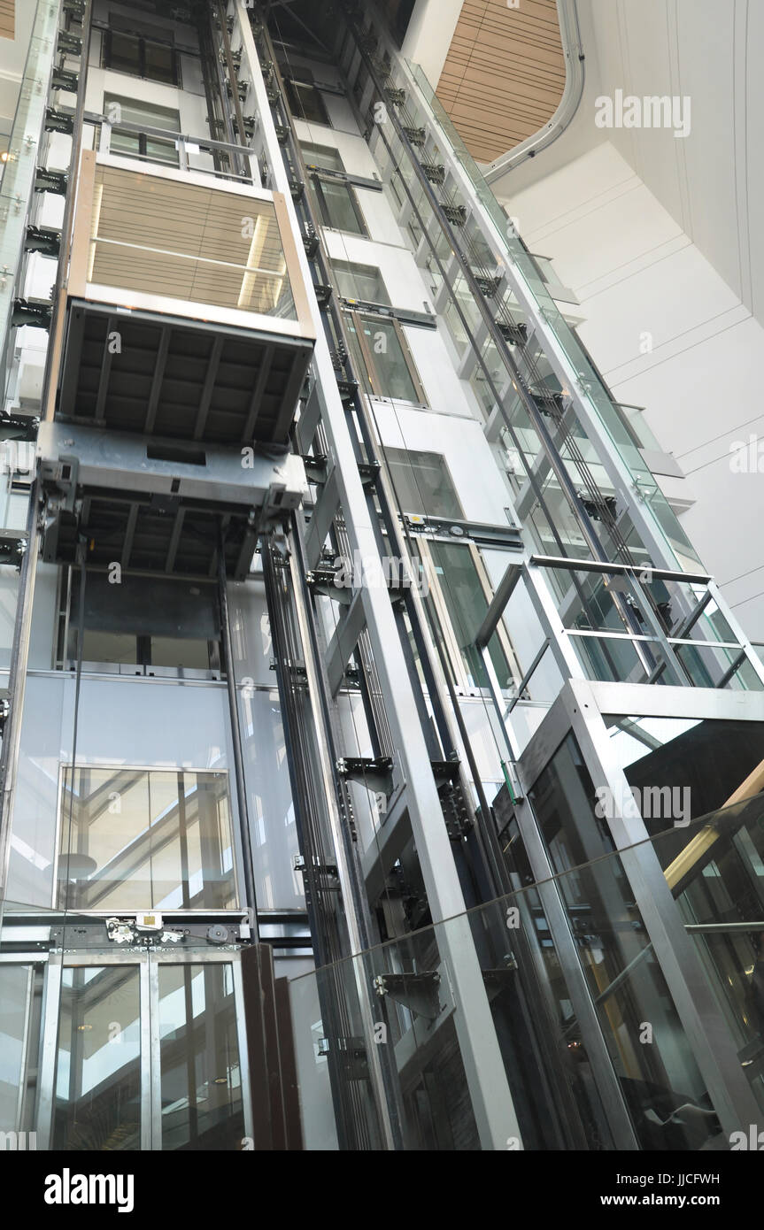 Glass see through elevators inside a mall Stock Photo