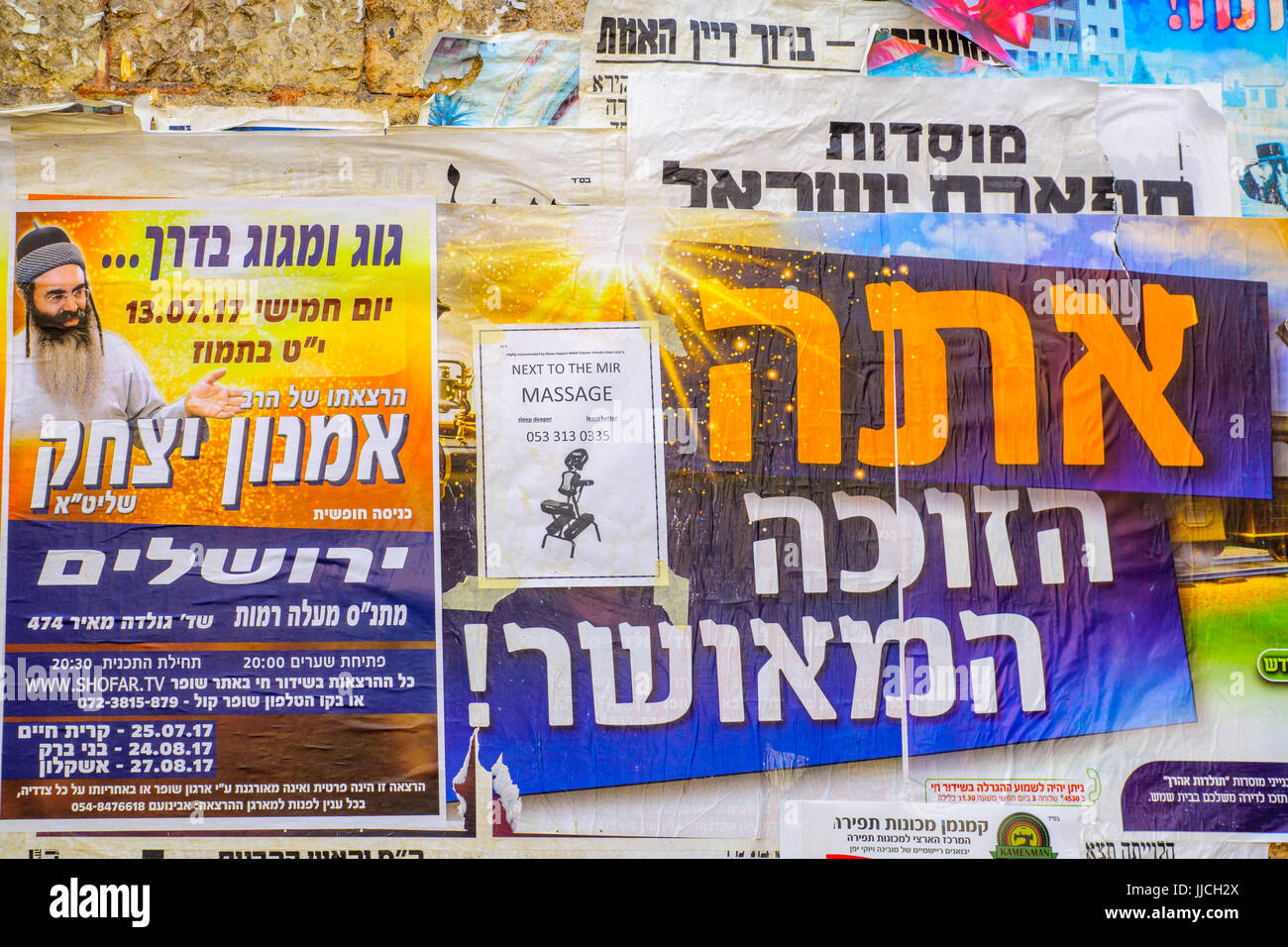 JERUSALEM, ISRAEL - JULY 12, 2017: Combination of posters about religious preaching, lottery and massages, in the ultra-orthodox neighborhood Mea Shea Stock Photo