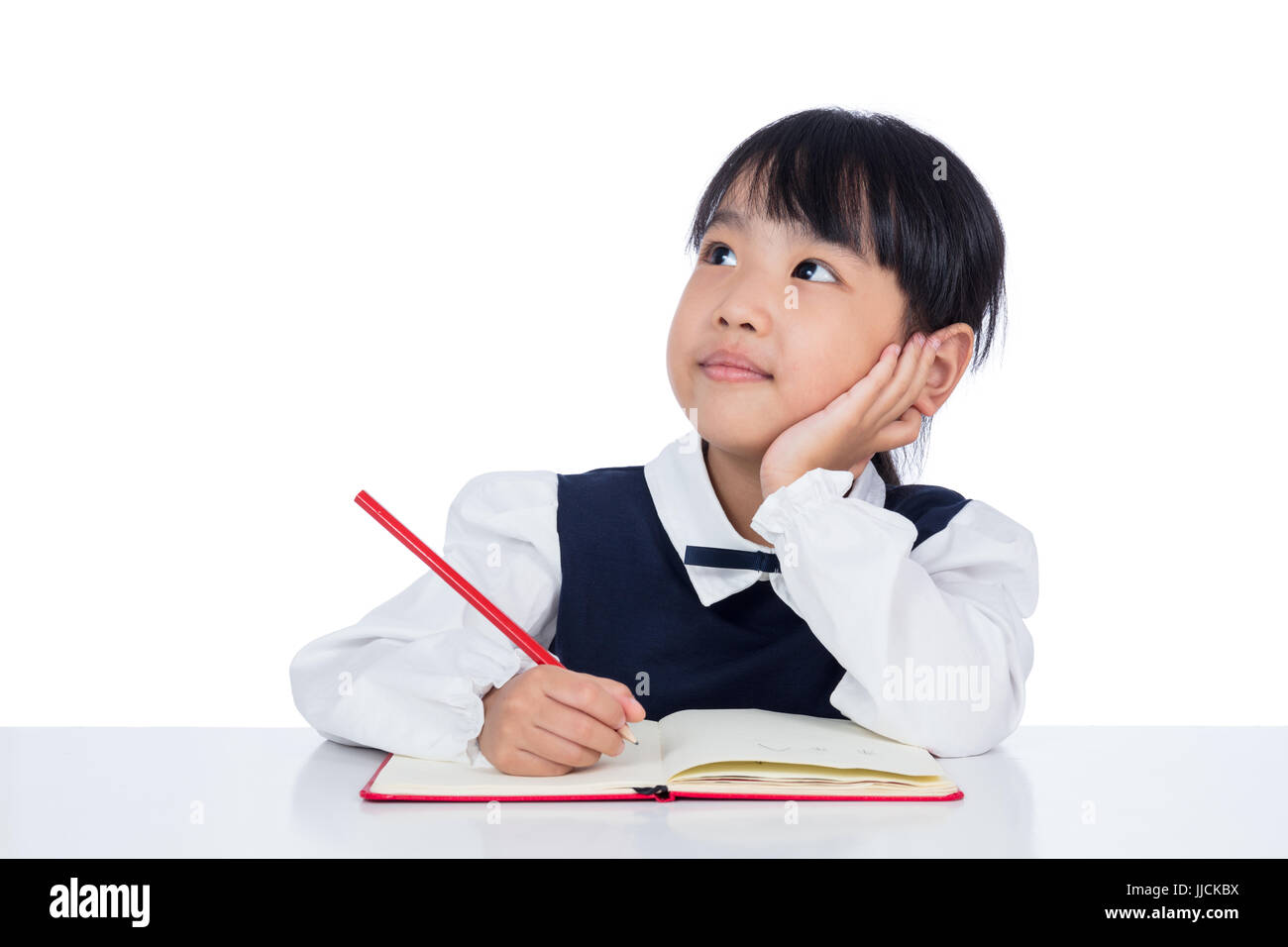 Asian Little Chinese girl writing homework in isolated white background ...