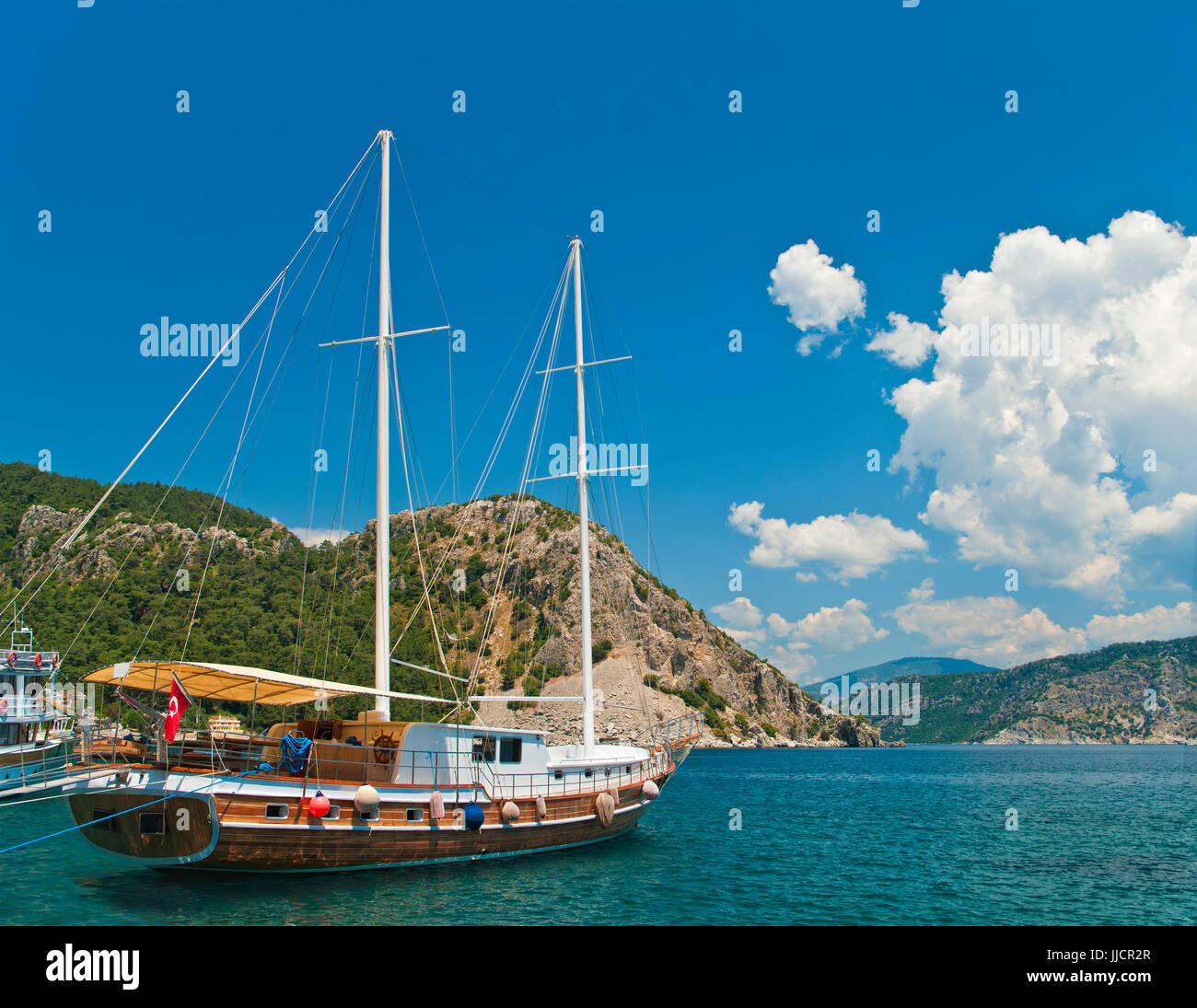turkish tourist boat moored at Marmaris bay in Aegean sea surrounded by mountains, Turkey Stock Photo