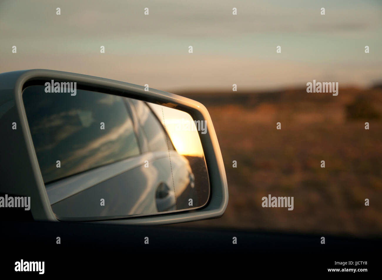 Reflects on the review mirror during a road trip Stock Photo
