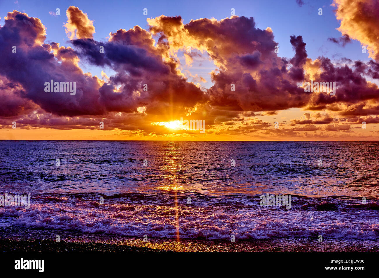 sunset over ocean. Sunset on the beach with beautiful sky. Dramatic ...
