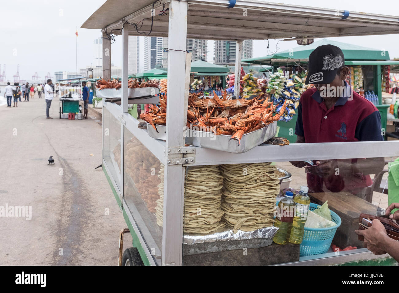 A street vendor sells crab and other food from a stall on Galle Face Green in Colombo, Sri Lanka Stock Photo