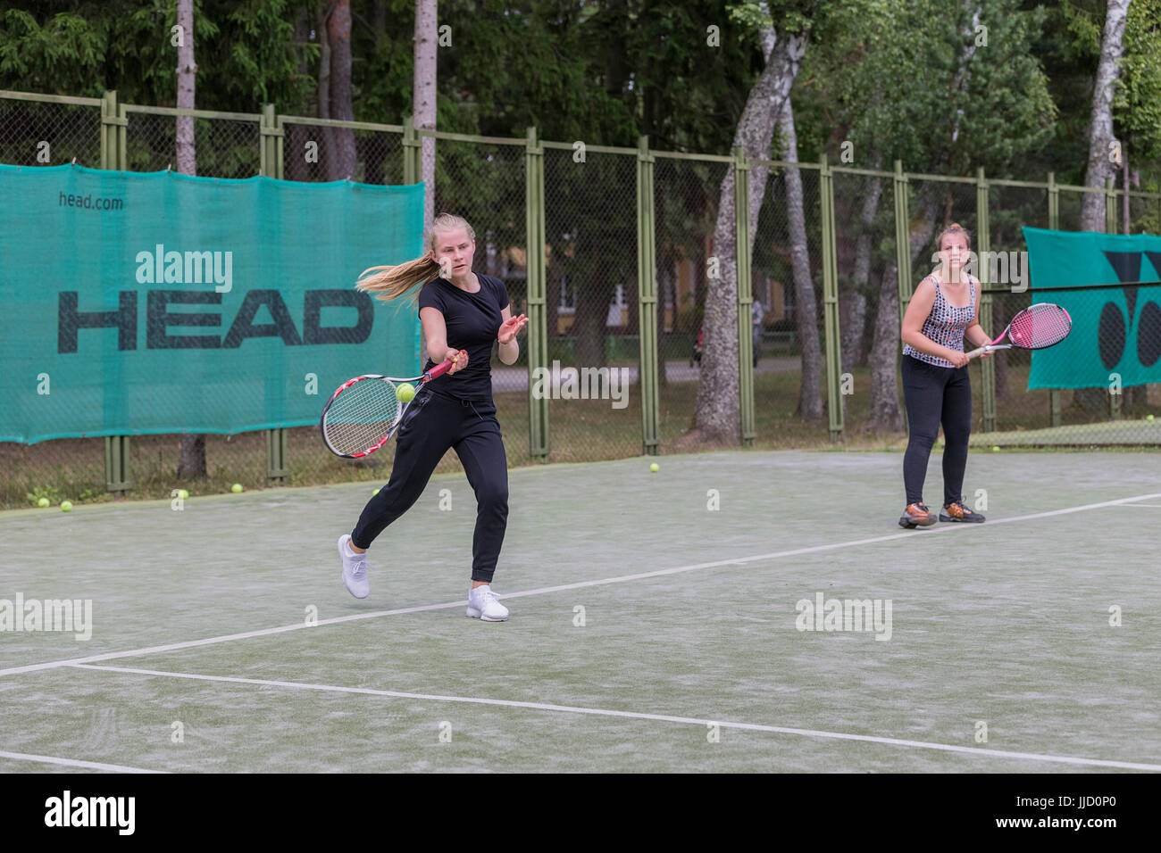 Female tennis player hitting ball on the tennis court, Palanga, Lithuania. Stock Photo