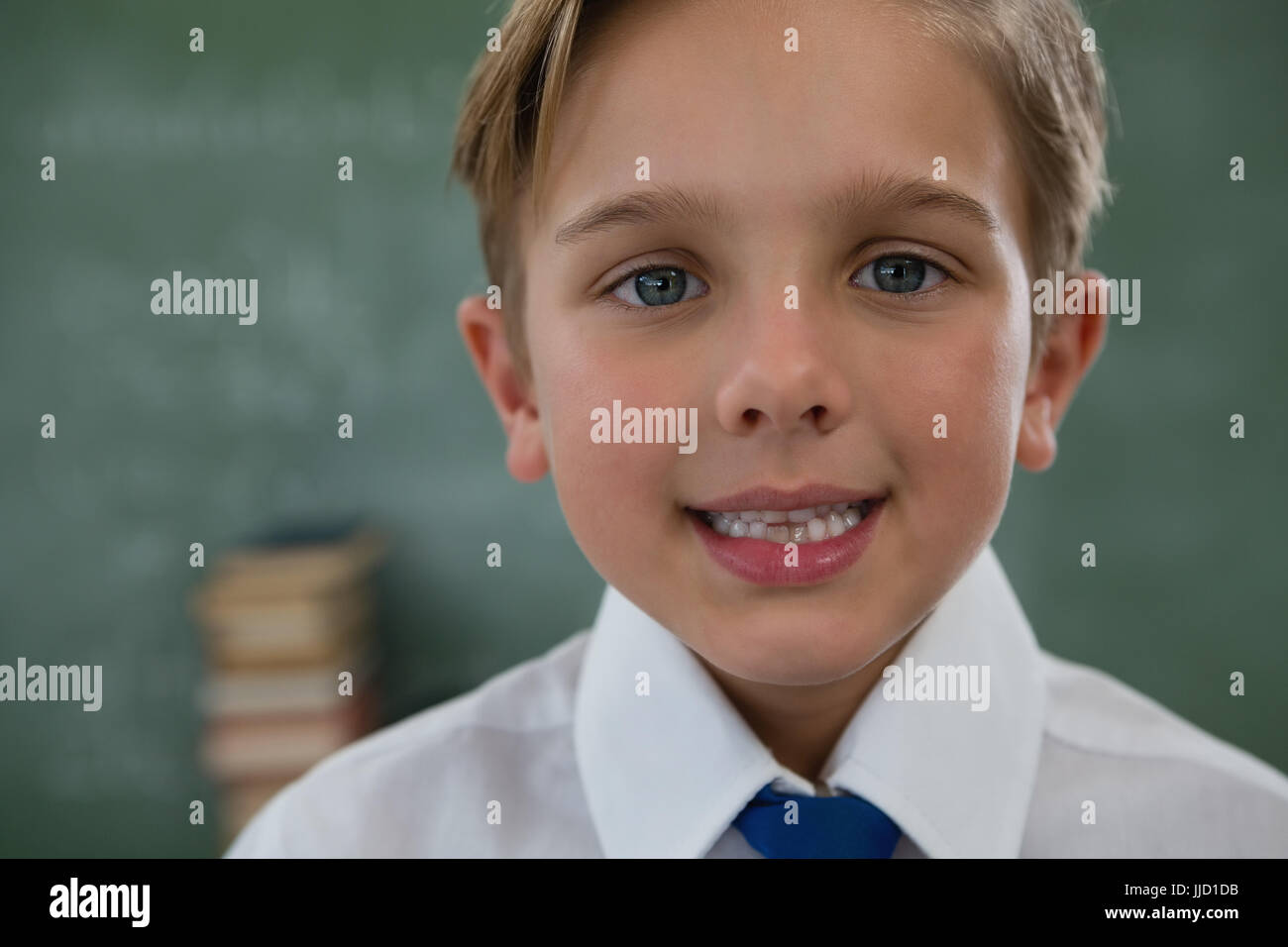 Portrait of smiling schoolboy against chalkboard Stock Photo - Alamy